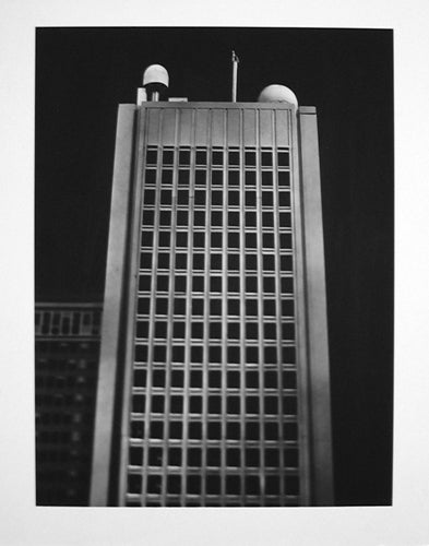 Photograph of the MIT Green Building at night.