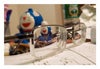 Close-up photograph of eyeglasses, homework, small stuffed animal.