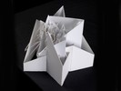 Photograph of white model with extruded and intersecting planes.