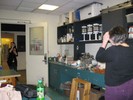 Photo of a student looking through her homemade telescope at another student across the room.