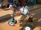 Photo of trike with mostly wooden frame and small wide tires.