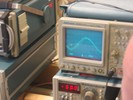 An oscilloscope displays the sinusoidal waveform of a whistling sound.