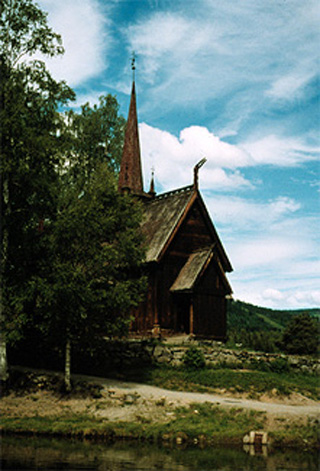 A pastoral church againt a bright blue sky.