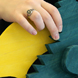 A student holds a wooden toy.