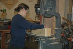 A student cuts a shear line.  Note the profile drawn in pencil on the side.