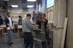 Instructors Chris Dewart and Reuben Smith set up the band saw.