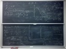 Radioactive decay related equations on two blackboards.