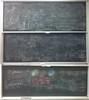 Photon interaction related equations on three blackboards.