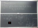 Nuclear interactions related equations on two blackboards.