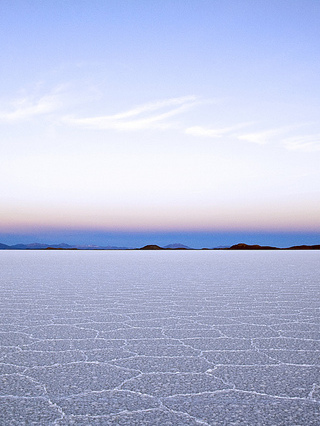 Sun beginning to rise over salt flats.