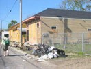 Debris from the houses on the street for collection.